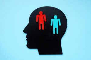 digital illustration of a human head silhouette with two human figures inside the head - bipolar disorders