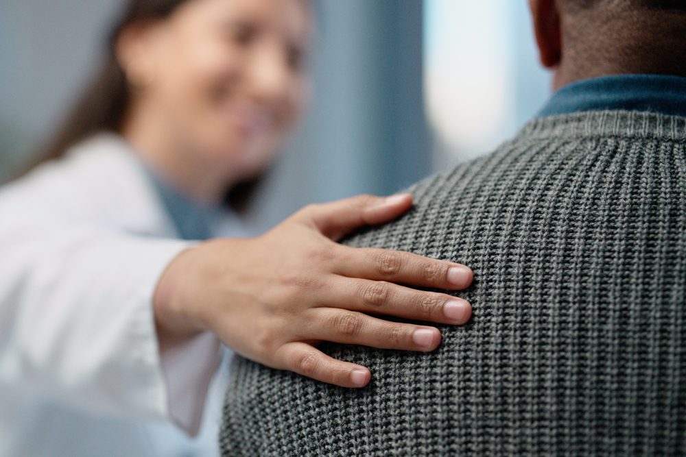 medical professional comforting a patient